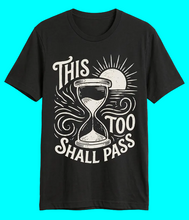 Load image into Gallery viewer, Black t-shirt with hourglass design and text 'This too shall pass' on a transparent background
